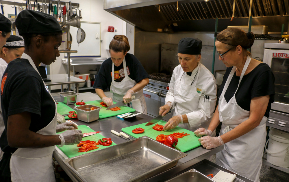 Participants learn kitchen knife skills in the Vermont women's correctional facility.