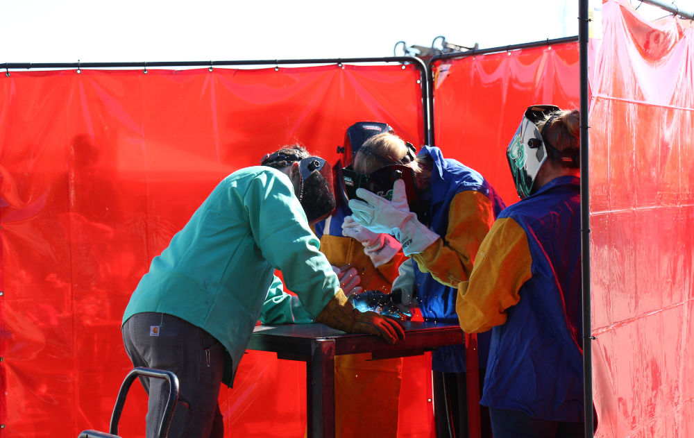 High school students try welding at Women Can Do.