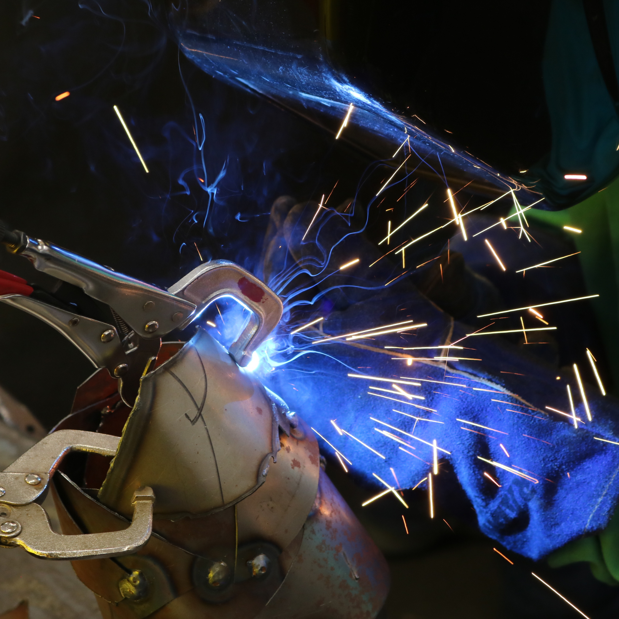 Sparks fly while welding at Rosie's Girls summer camp where middle school girls learn welding skills