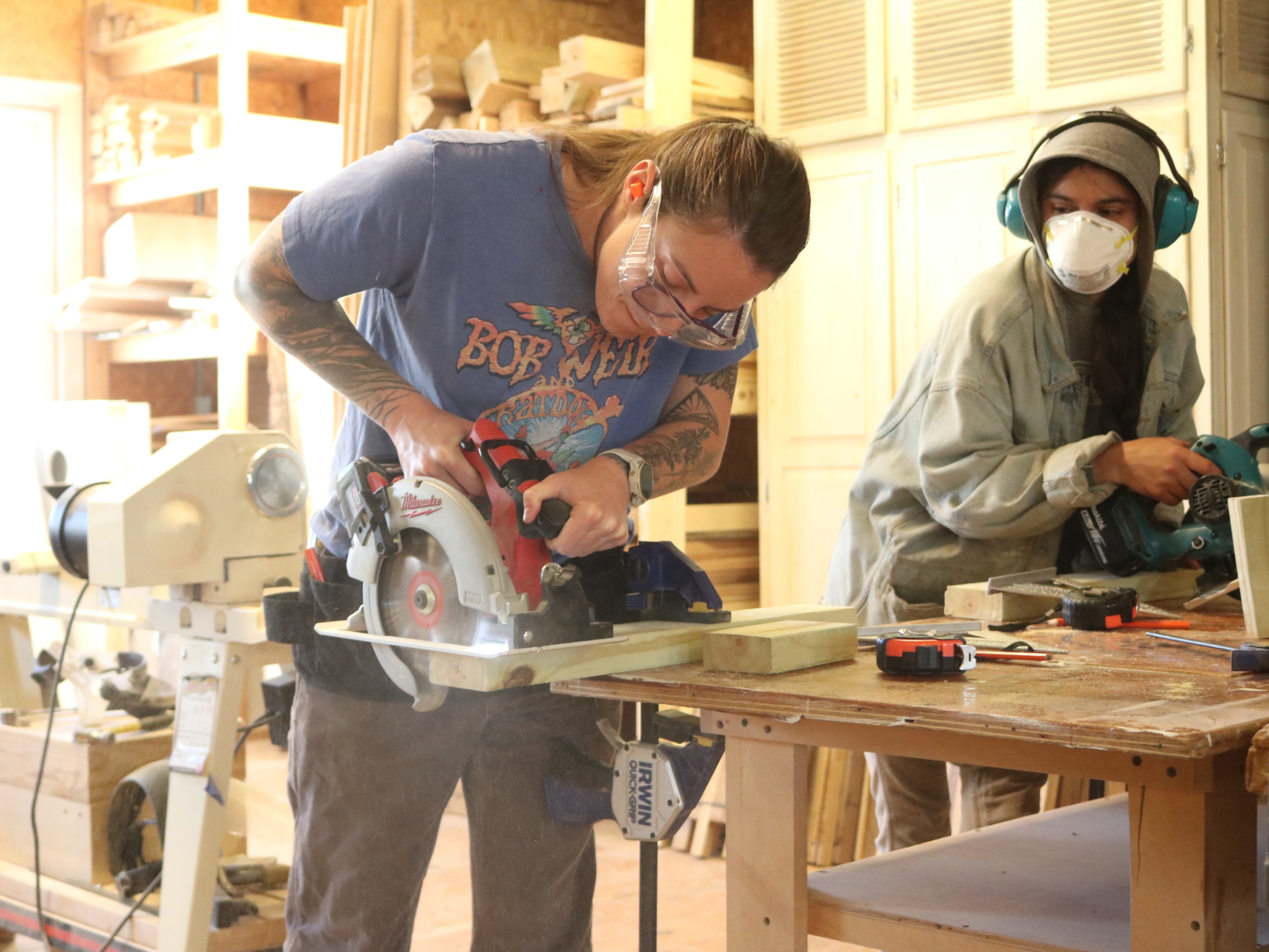 A Trailblazer practices using a circular saw during the trades training.