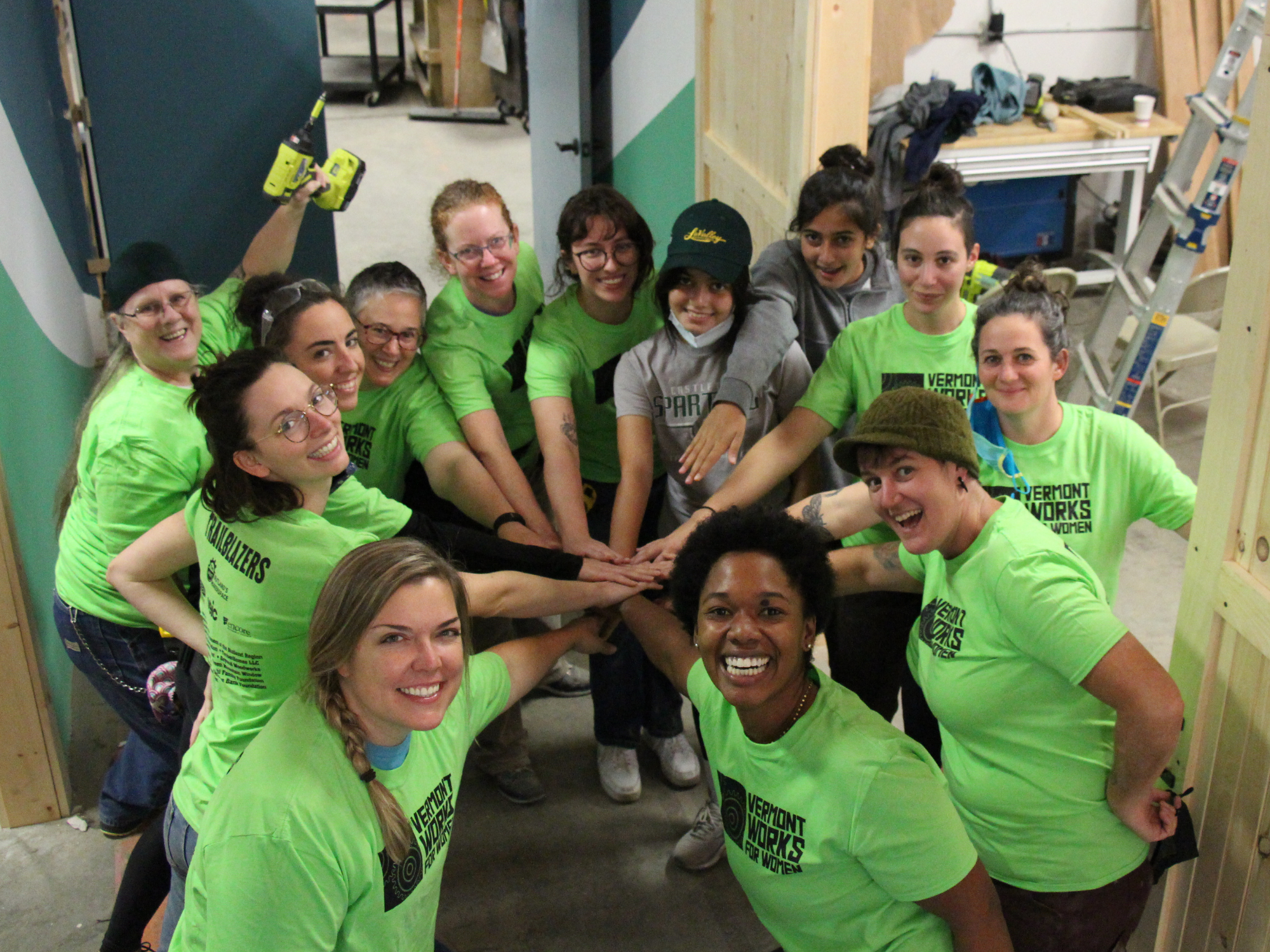A group of Trailblazers poses for a photo after successfully installing a sliding barn door during the trades training program.