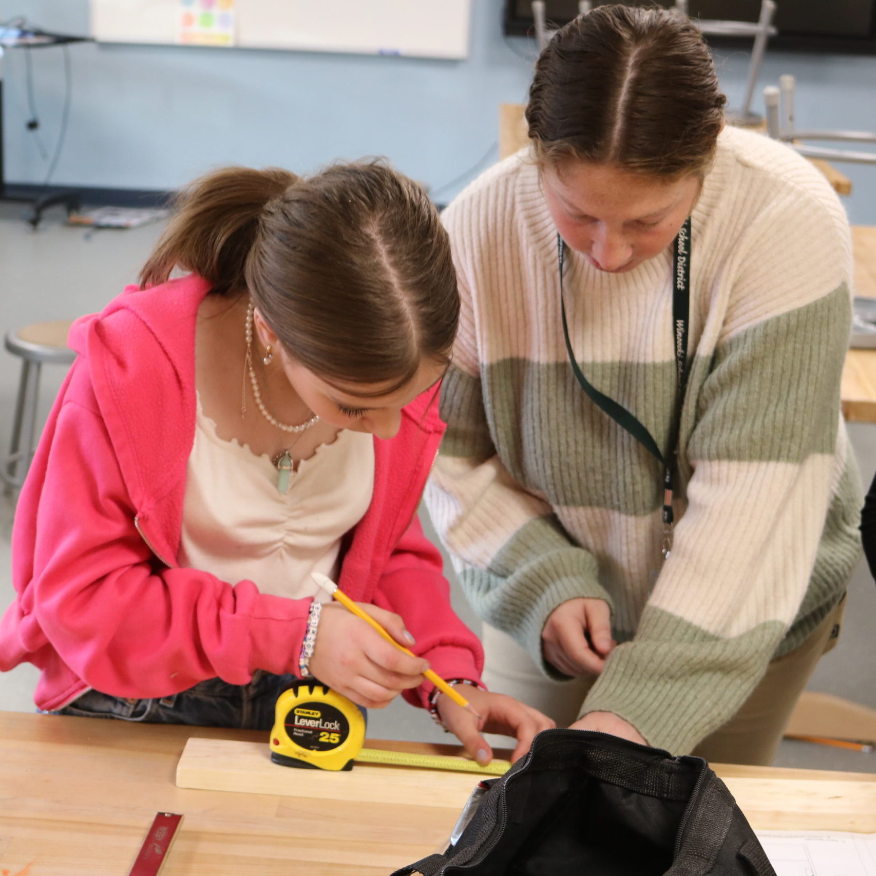 Middle school student measures with instructor for Rosie's Girls Afterschool