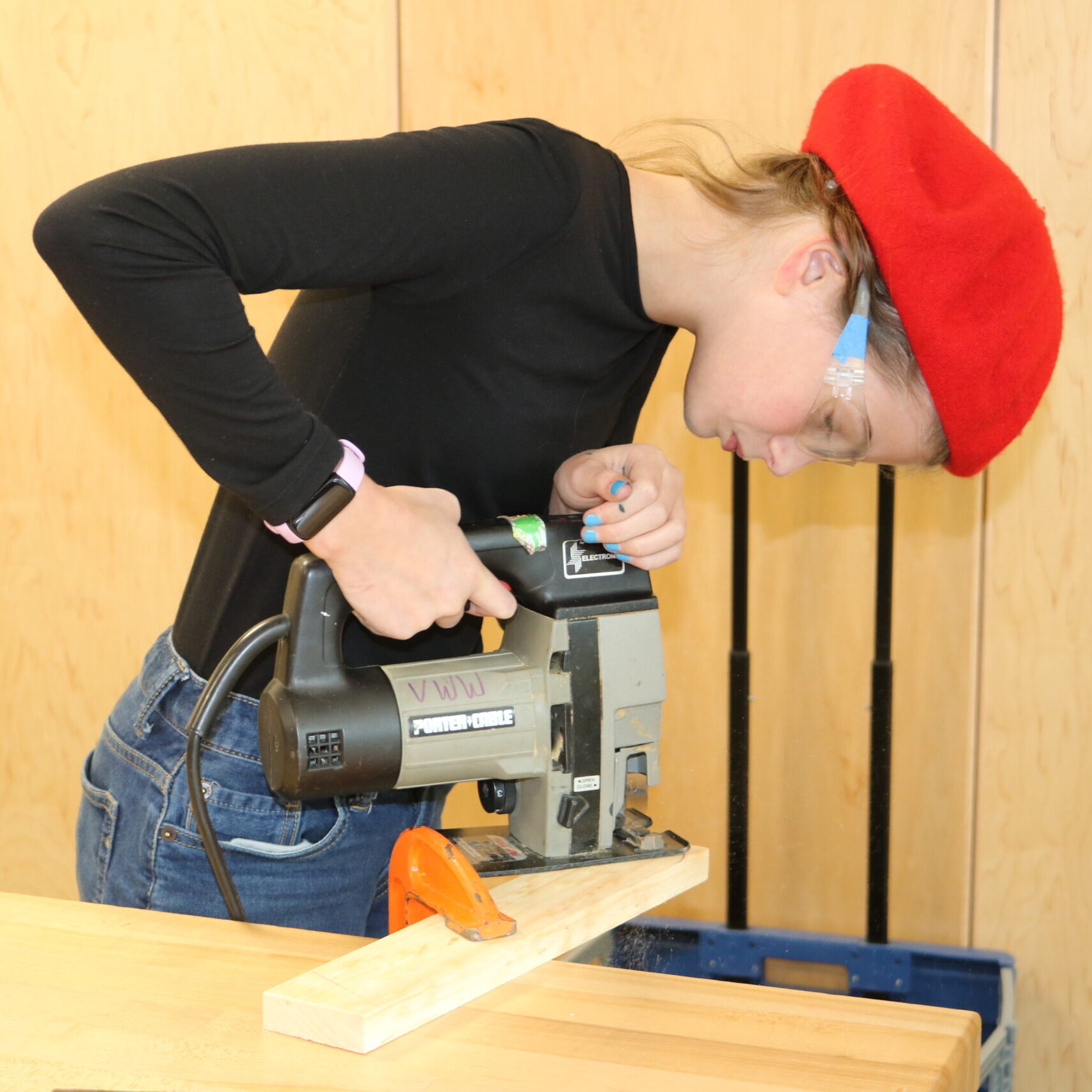 Middle school student uses a reciprocating saw in Rosie's Girl's afterschool
