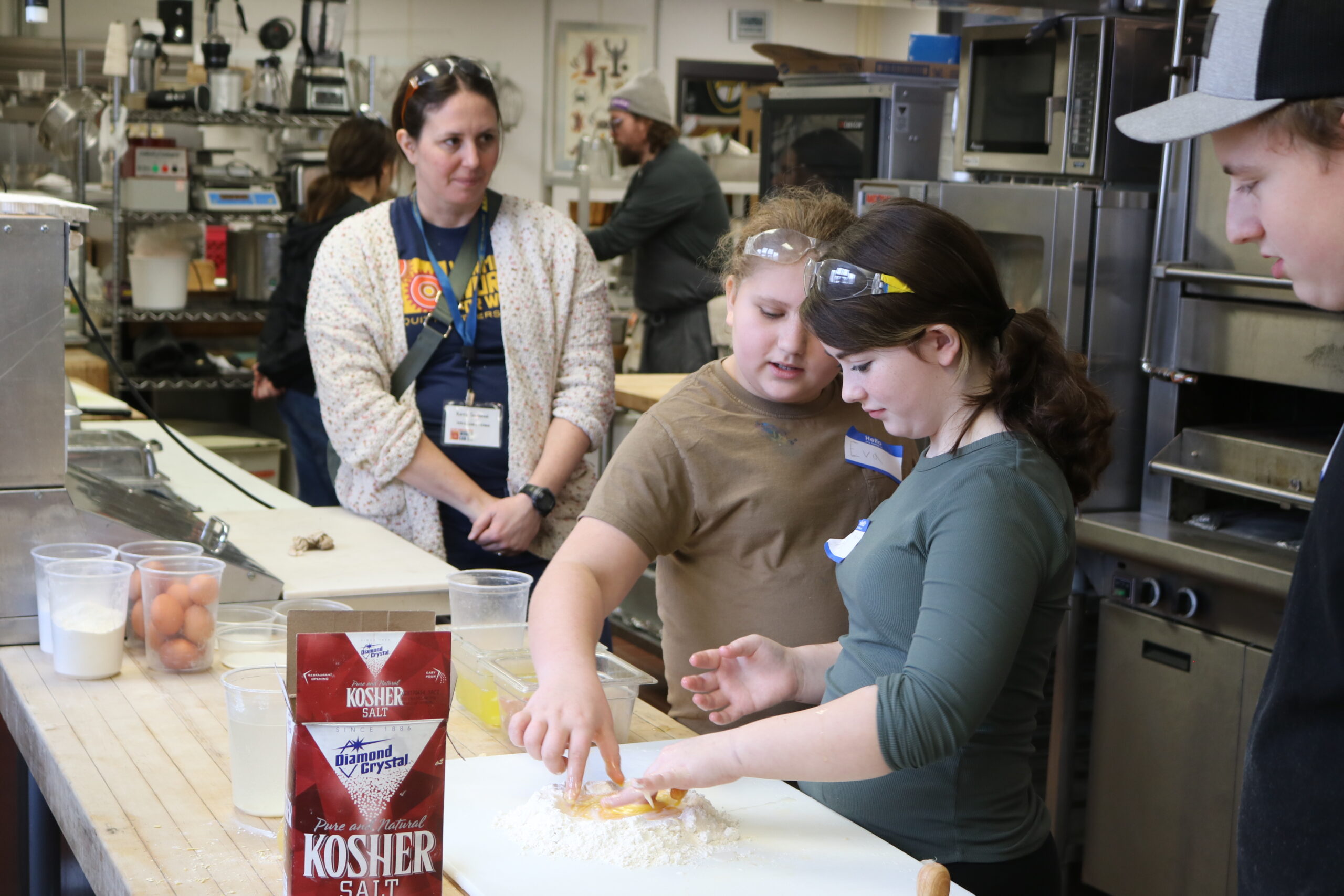 Middle school students try making pasta at Career Challenge Day