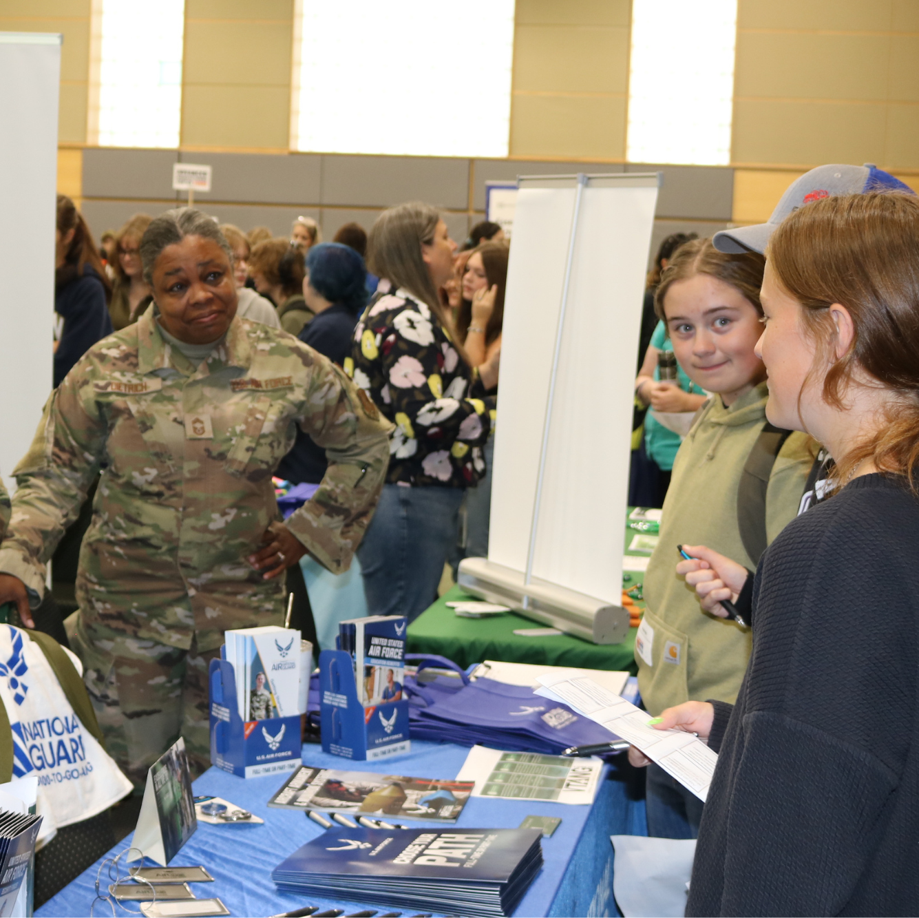 Students talk with an exhibitor in the Resouce Hall at Women Can Do.