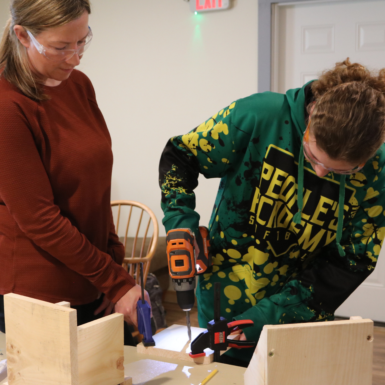 Middle school student uses a drill to build a birdhouse during Rosie's Girls Afterschool