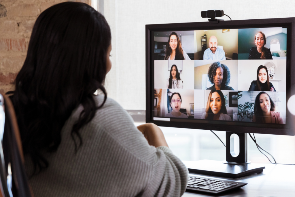 Woman meets virtually with a group of people.