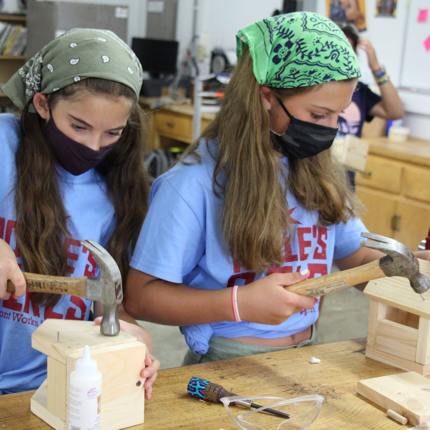 Two Campers use hammers to build birdhouses at Rosie's Girls Camp