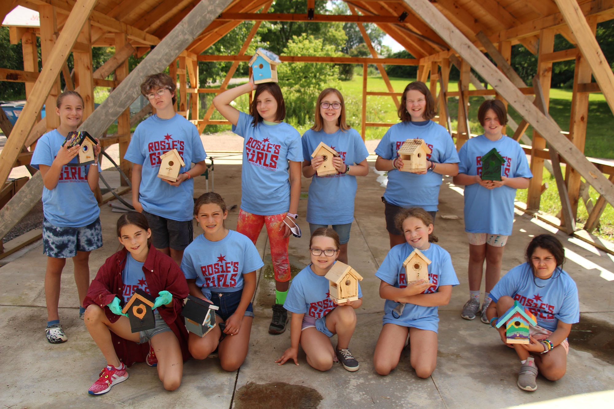 osie’s Girls campers pose with their hand built, decorated birdhouses.