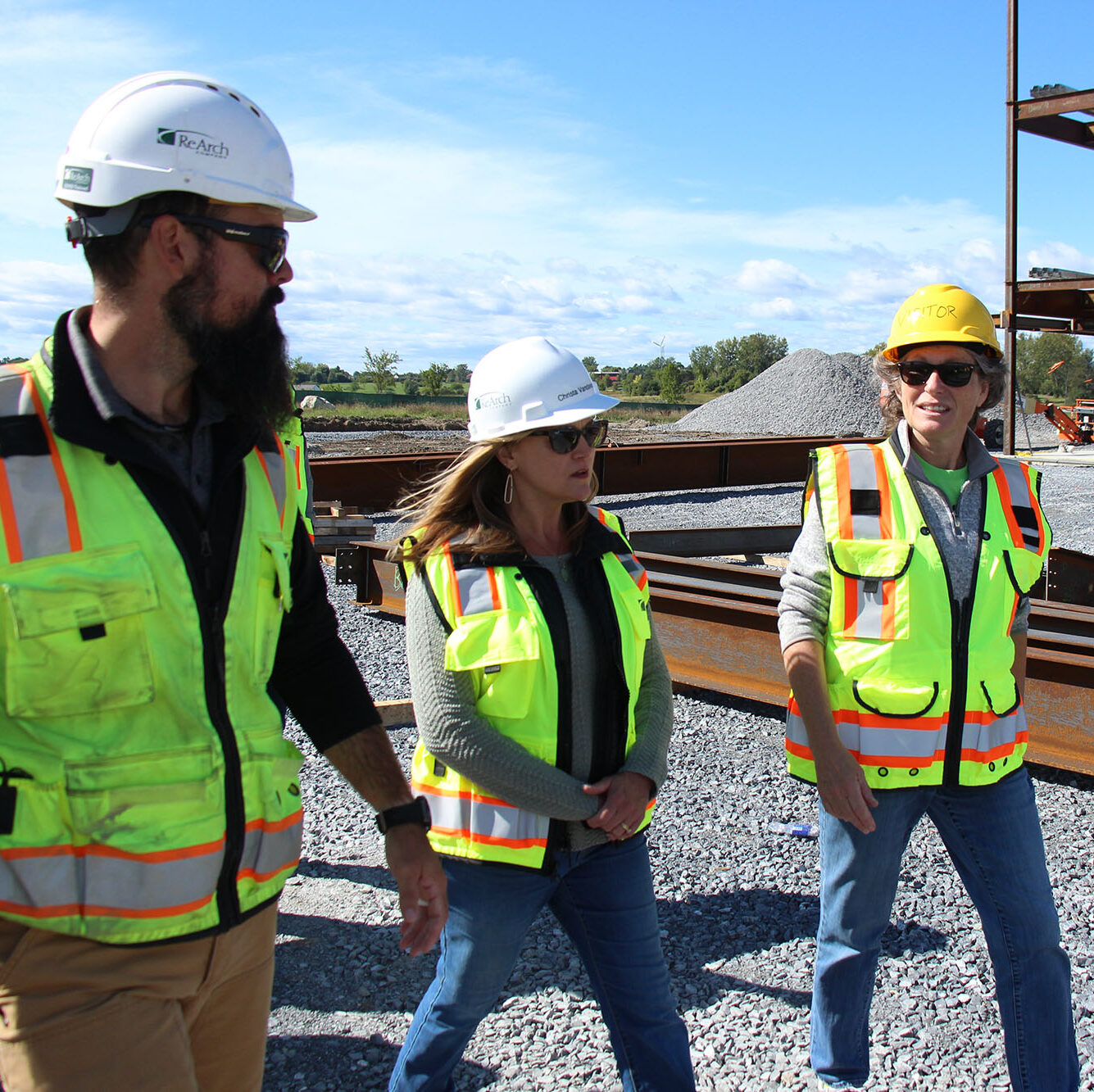 Trailblazer staff member walks with ReArch Construction Company staff at a construction site.