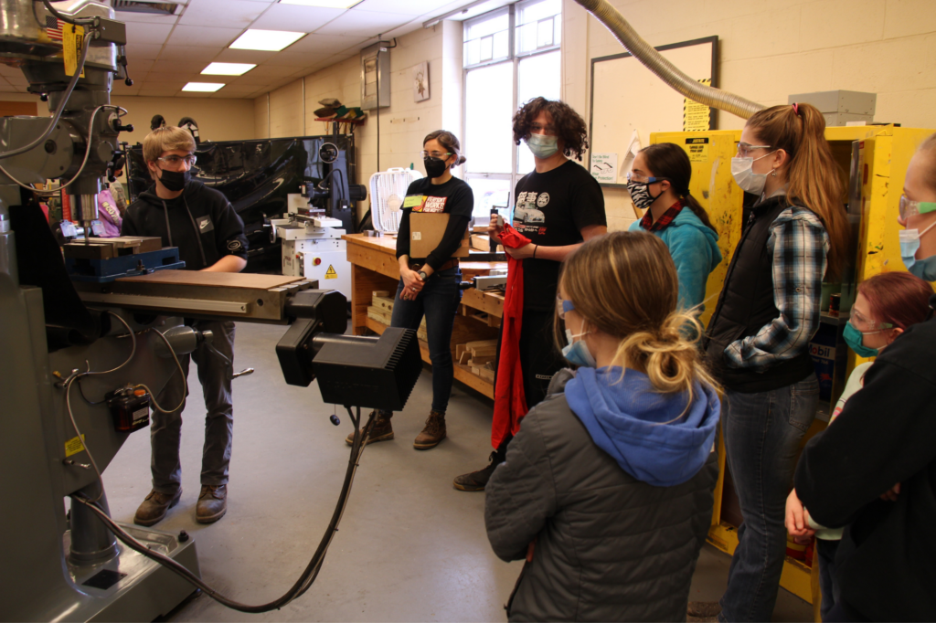Students tour machines in advanced manufacturing classroom.