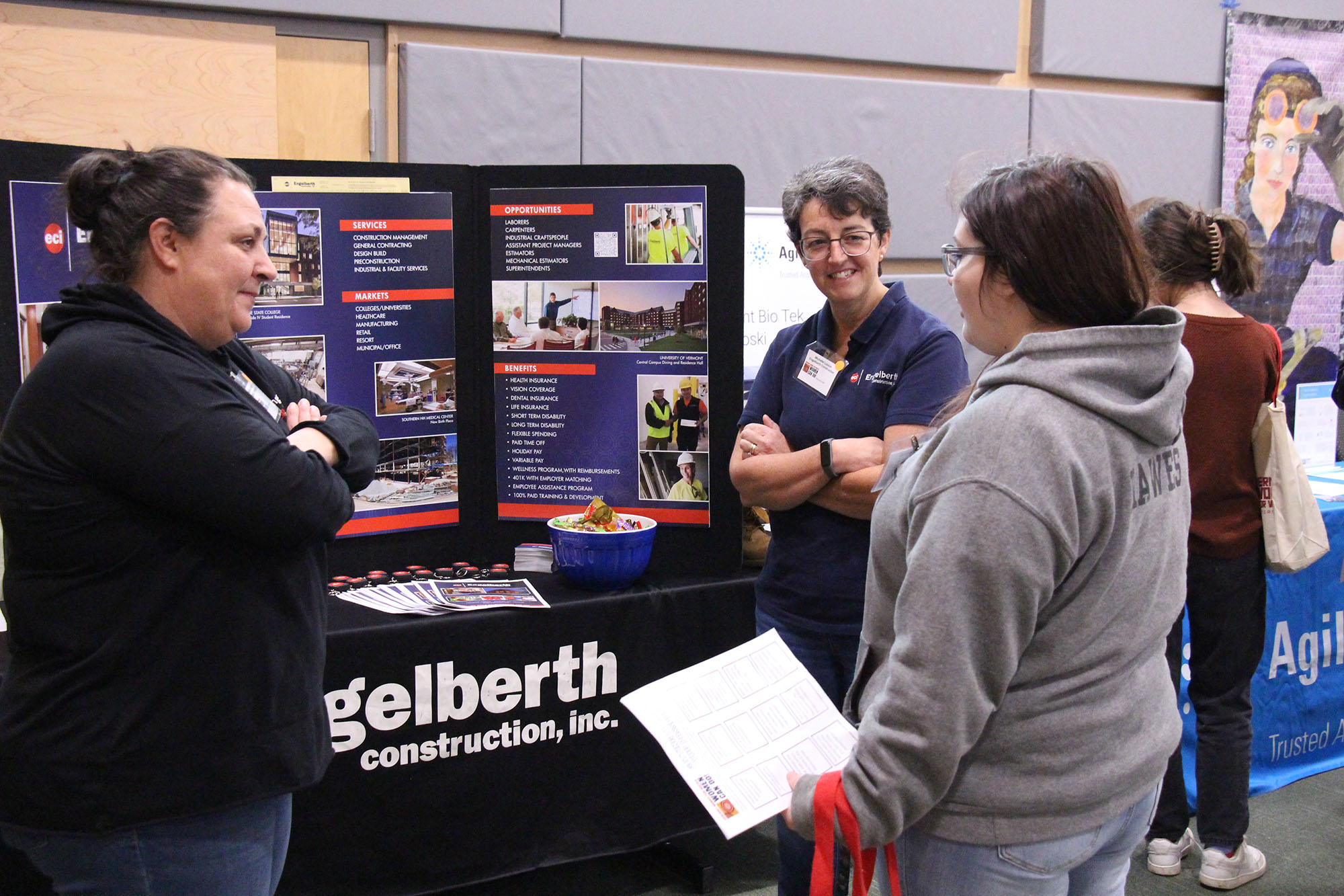 Employees of Engelberth speak to a high school student at the Women Can Do conference.