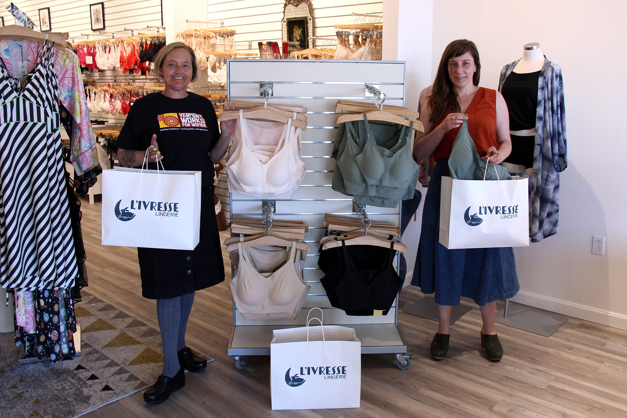 Vermont Works for Women Program Manager Heather Newcomb poses for a photo with L'ivresse Lingerie owner who collects and donates bags of bras for incarcerated women.
