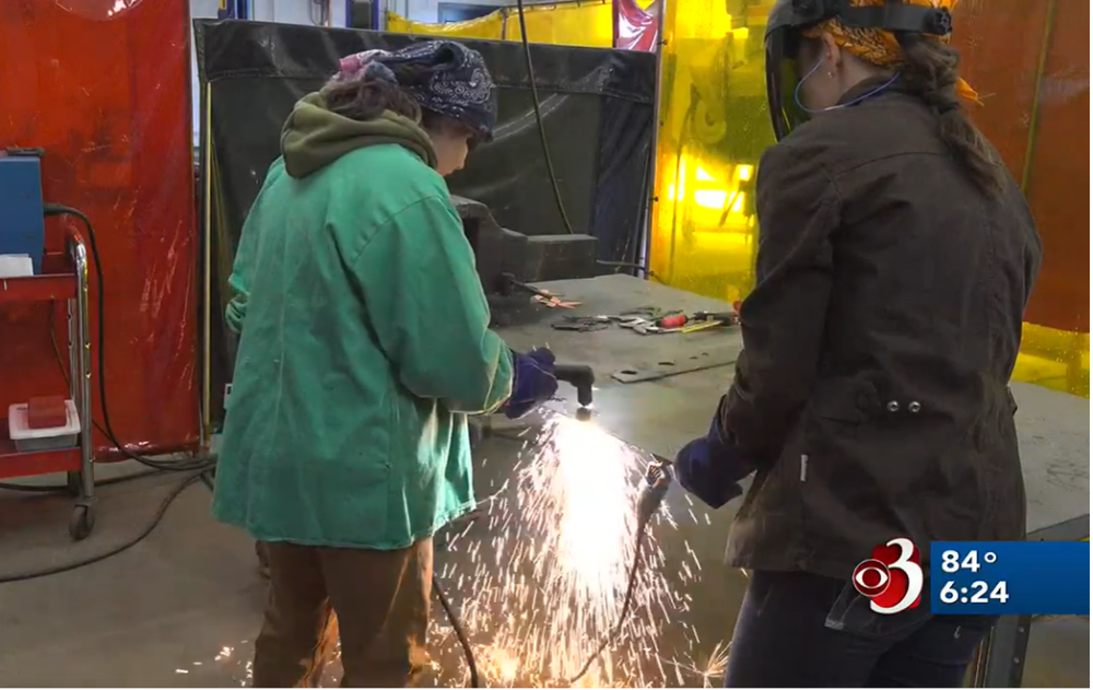 Rosie's Girls Campers use a plasma cutter at the vermont summer camp.