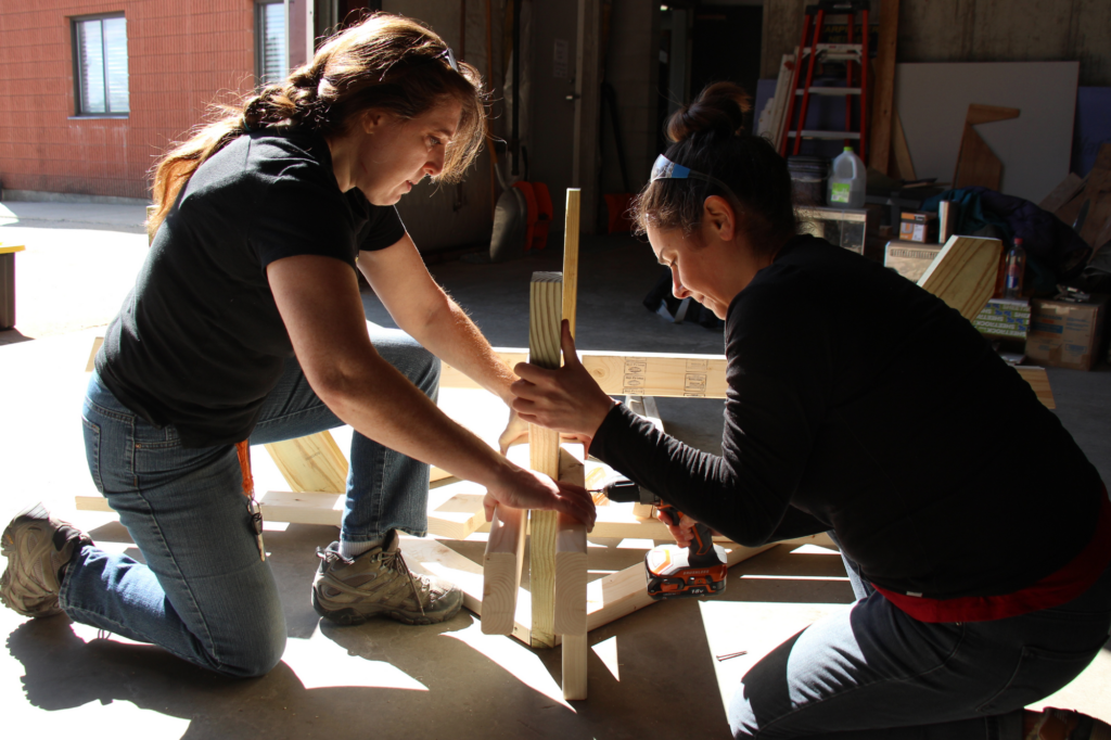 Two Trailblazers work together to build a picnic table.