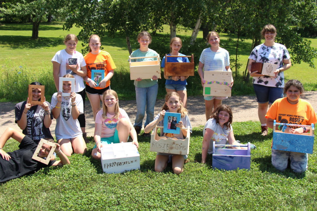 Rosie's Girls campers pose with the wooden projects them built.