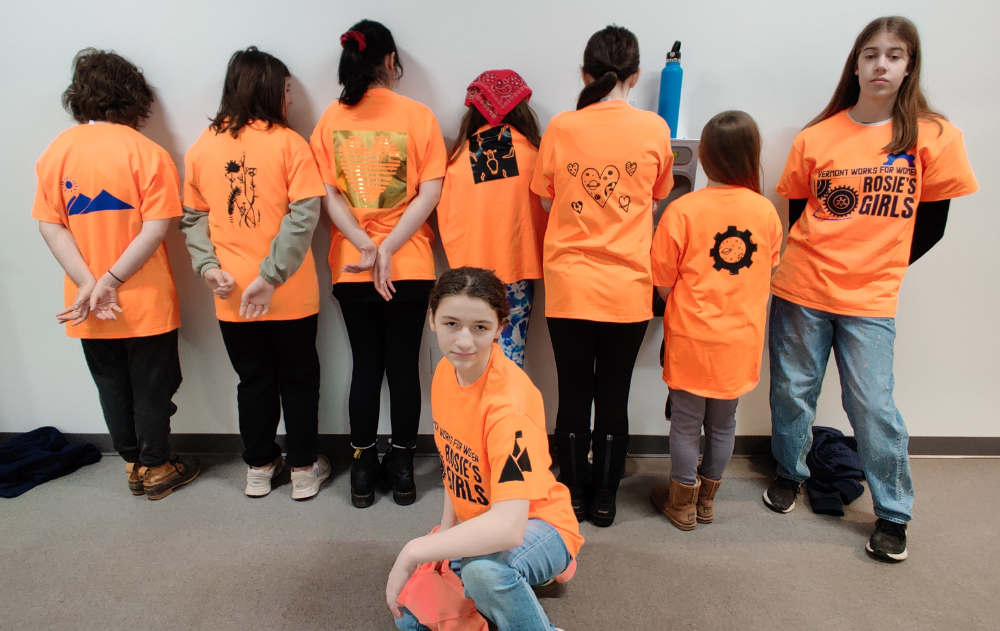 Campers at Rosie's Girls February break camp show off the vinyl stickers they created on the back of their shirts.