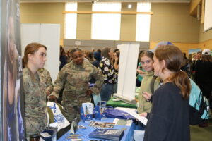 Students chat with the women wit the Air National Guard at Women Can Do