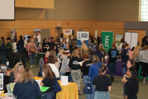 Students visiting with employers and organizations in the Resource Hall of Women Can Do
