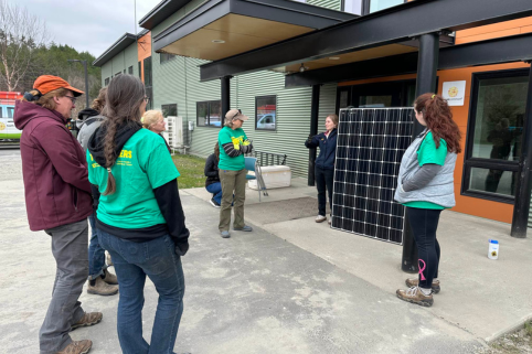 Instructor Maddy shows the class a solar panel.