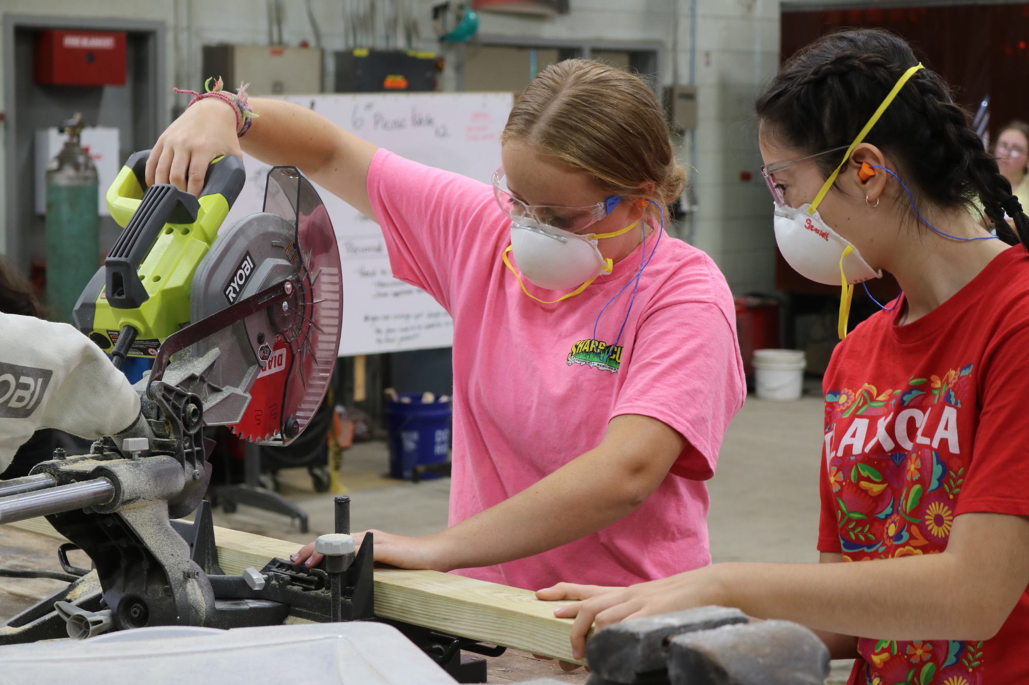 High school students use a saw during our LIFT summer programs