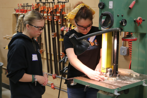 Middle School student uses woodworking tools during Career Challenge Day