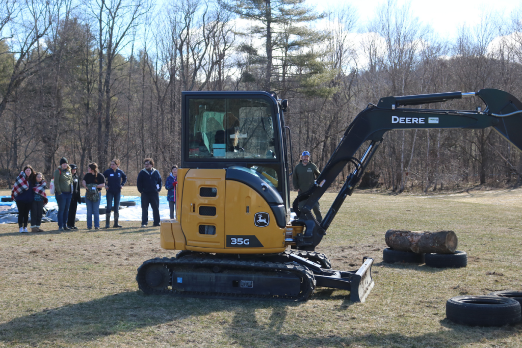 A middle school girl tries using a backhoe at Career Challenge Day