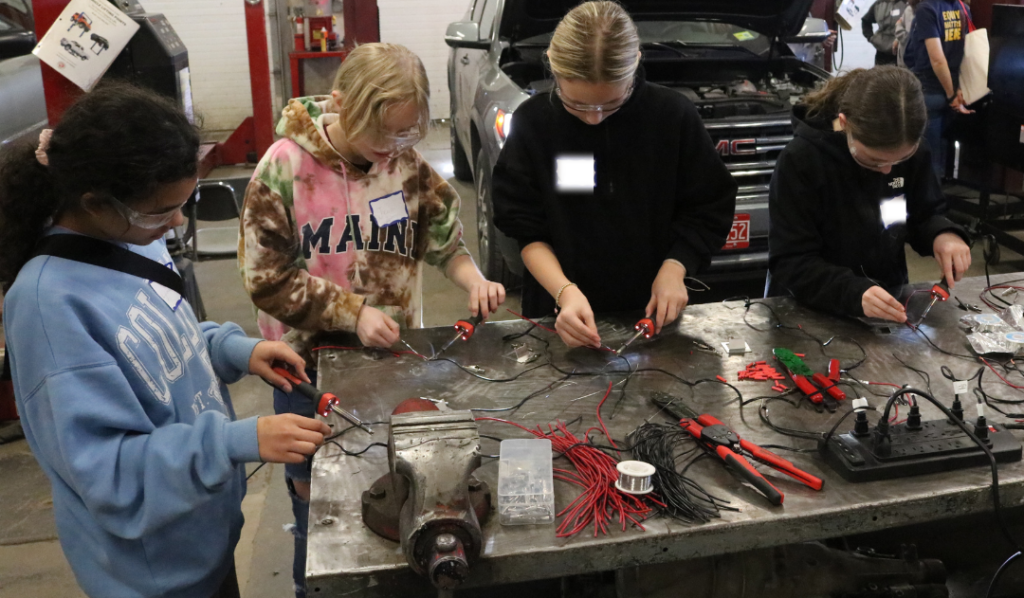 Middle school girls at Career Challenge Day try soldering metal