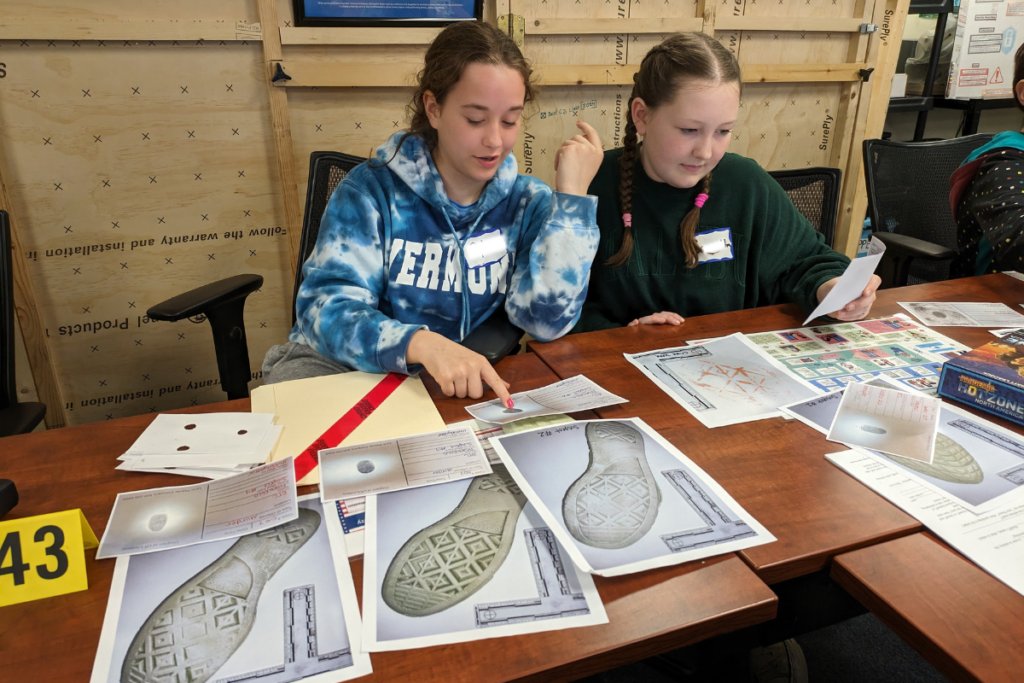 Students examine footprints and fingerprints at Career Challenge Day