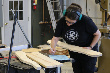 A trailblazer refers to instructions while building an Adirondack chair.