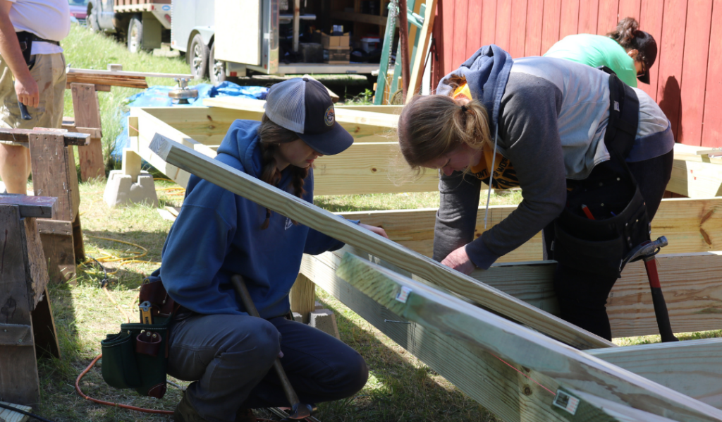 Two Newport Trailblazers participants work together to build a deck