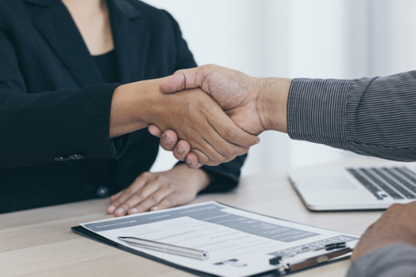 Employer welcomes a new employee with a handshake