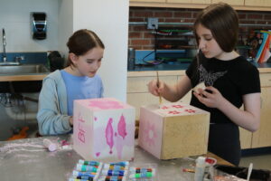 Students paint the dice they made 