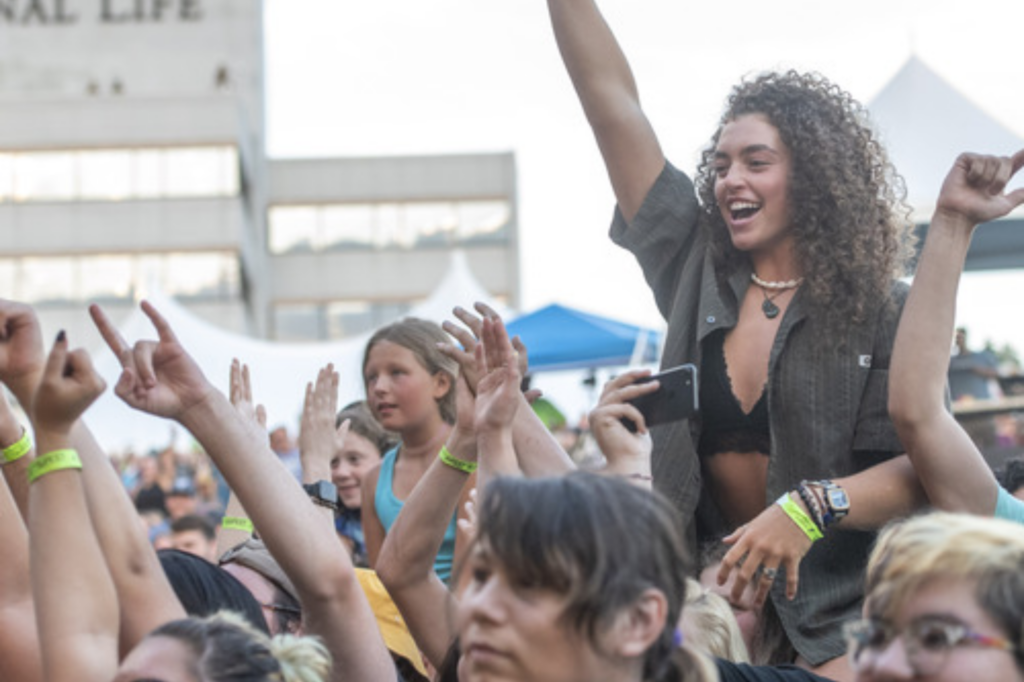 Crowd members smile at Do Good Fest concert in Montpelier