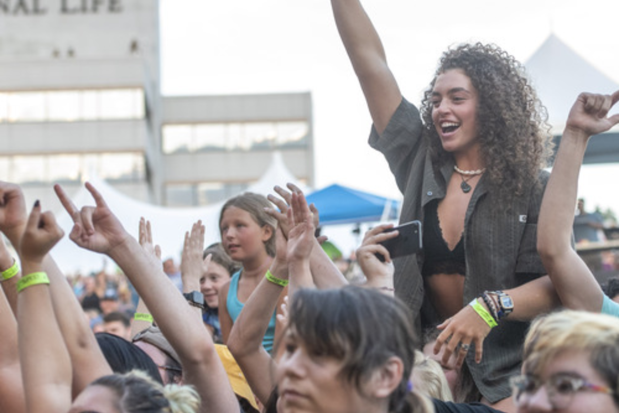 Crowd members smile at Do Good Fest concert in Montpelier