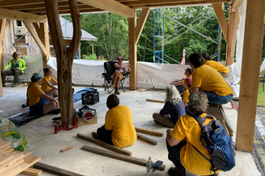 Trailblazers sit and listen to Anneke share about her timberframe building