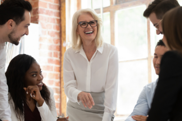 Woman speaks to group of coworkers