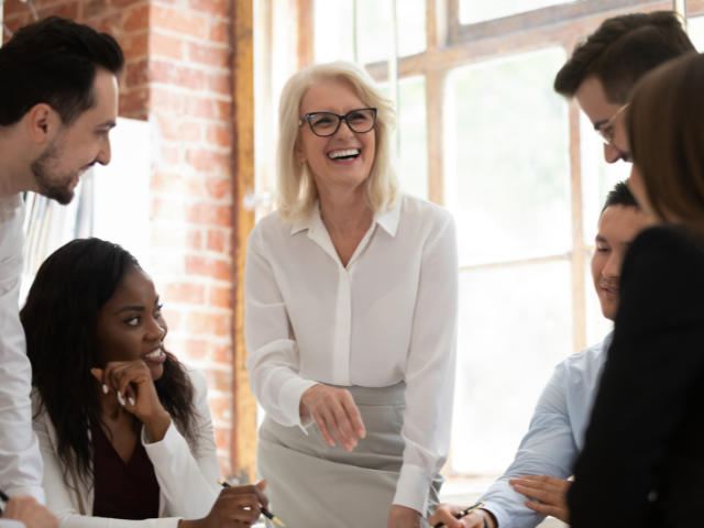 Woman speaks to group of coworkers