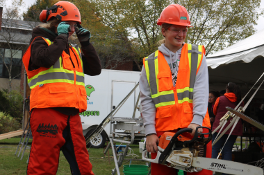 Student holds a chainsaw at Women Can Do 2024