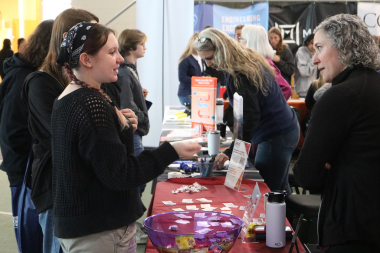 Student talks with exhibitor in the Resource Hall at Women Can Do.