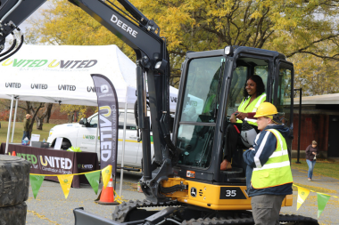 Participant learning how to operate heavy machinery at Women Can Do 2024