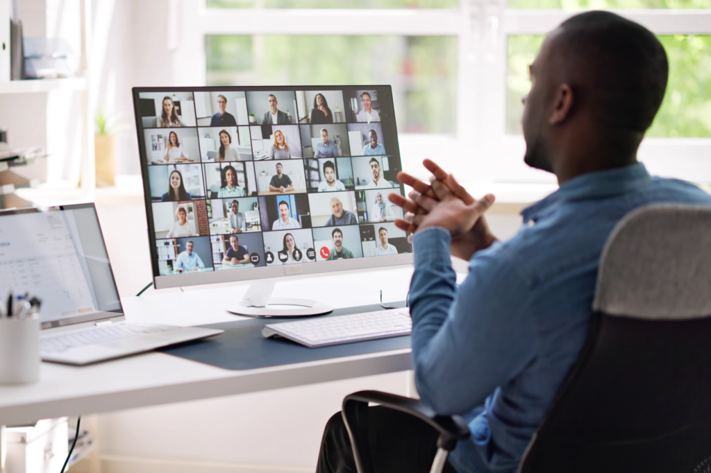 Man looks at screen during virtual meeting