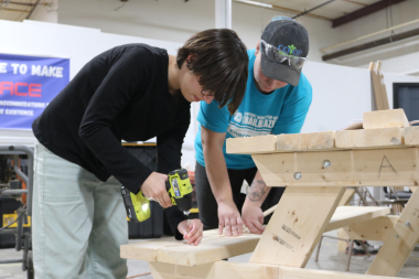 Trailblazer participant uses a drill to build a picnic table