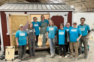 Trailblazers: Energy Works graduates pose in front of shed.