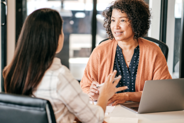 Women meet for a performance review at work