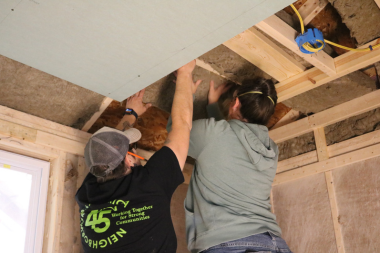 Trailblazers place insulation in the shed during Weatherization day