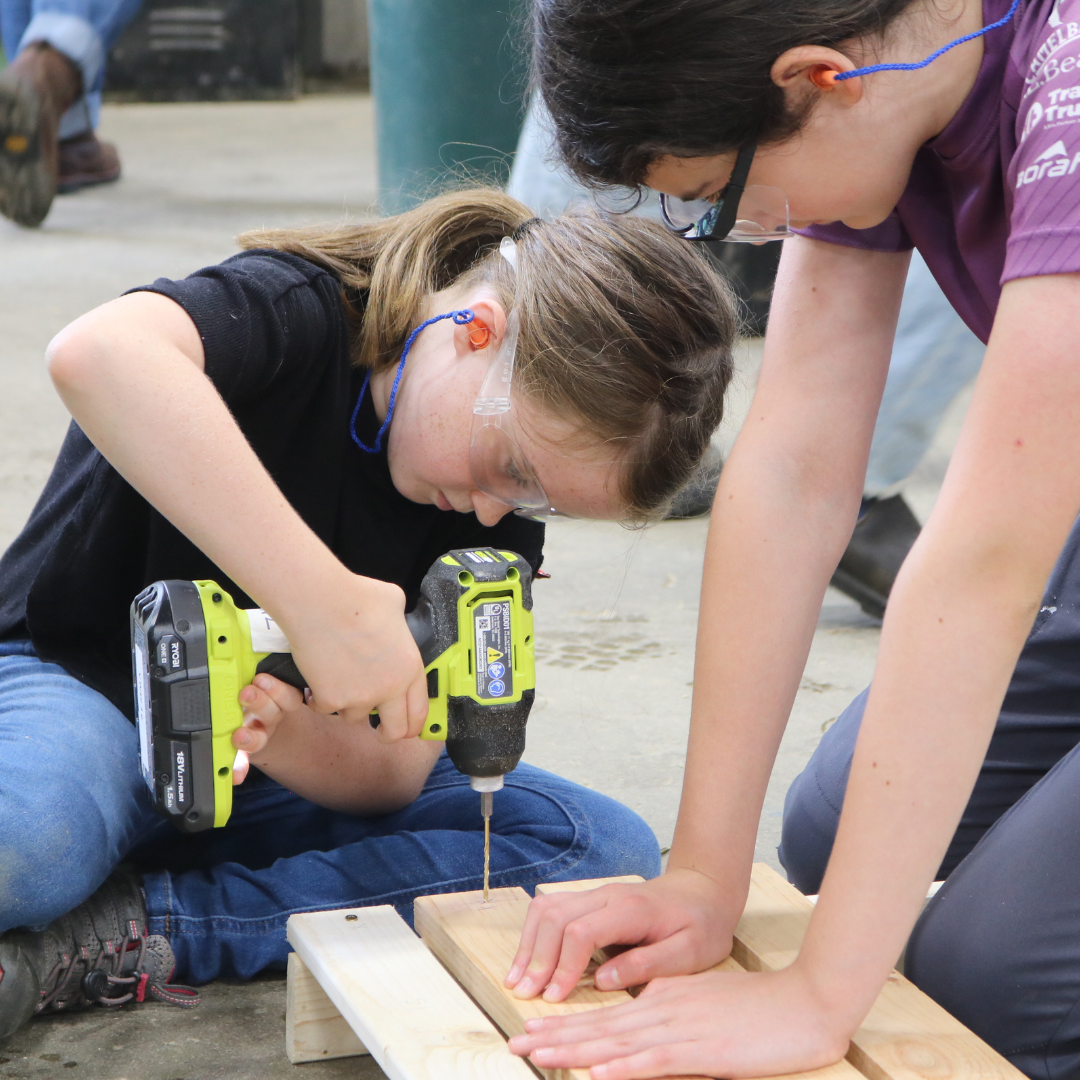 Rosie's Girls campers use power tools at summer camp.