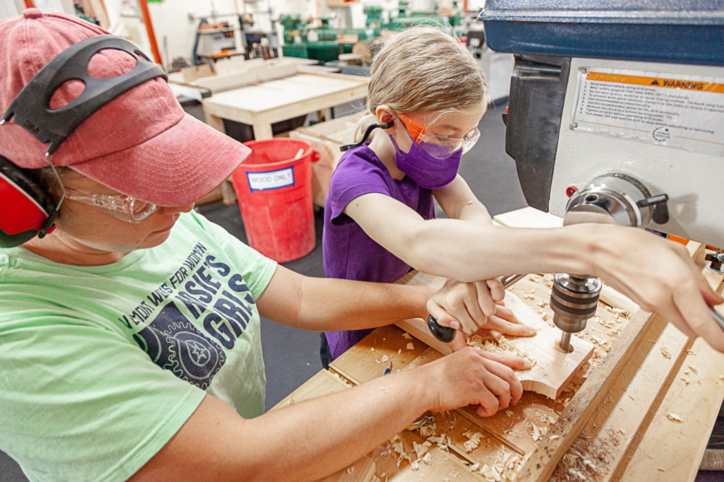 Camper uses tools with help from the instructor at Rosie's Girls at HatchSpace