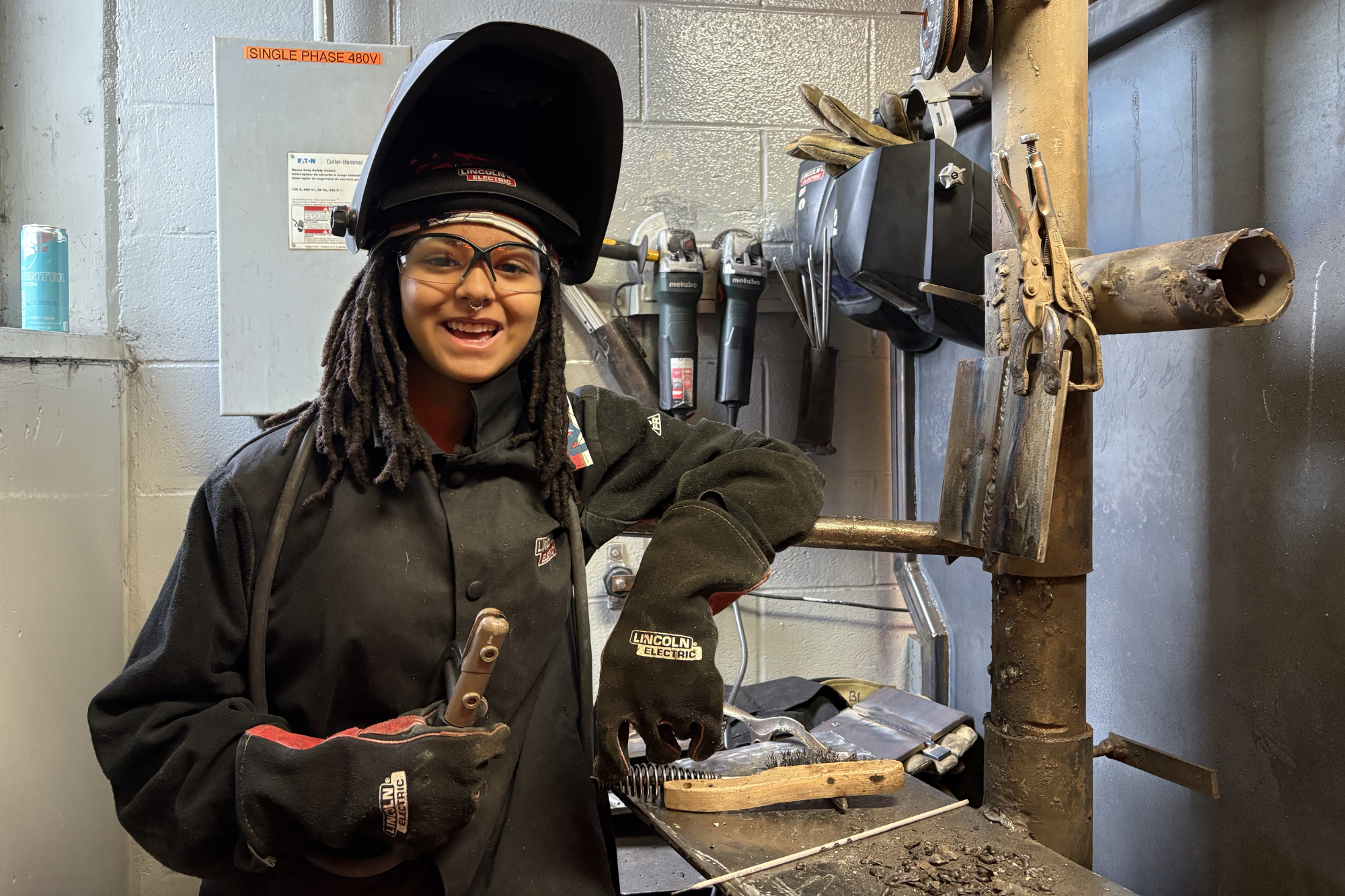 Jael Francis poses in welding booth at North Country Career Center.