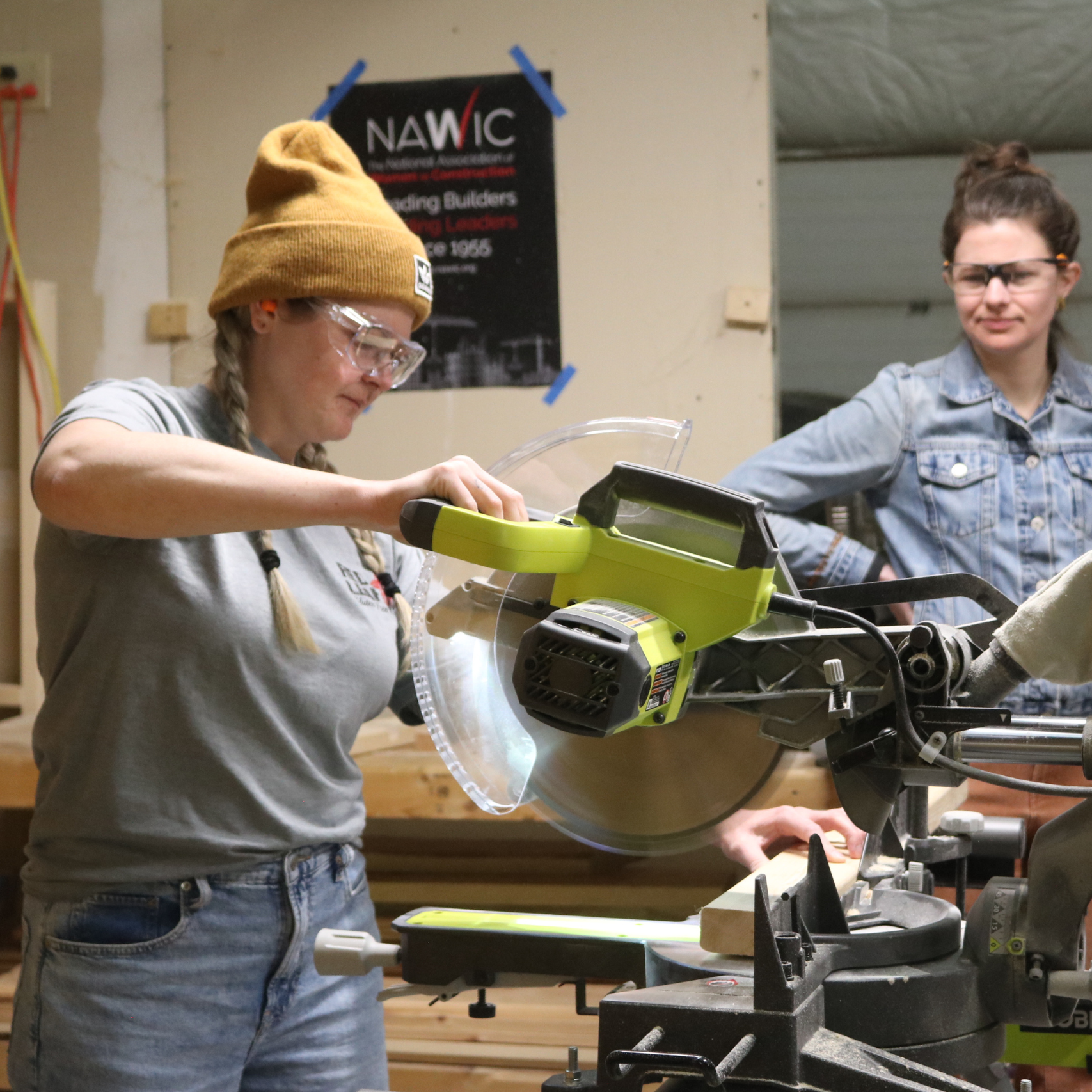 Woman uses saw during Trailblazers trades training program for women.